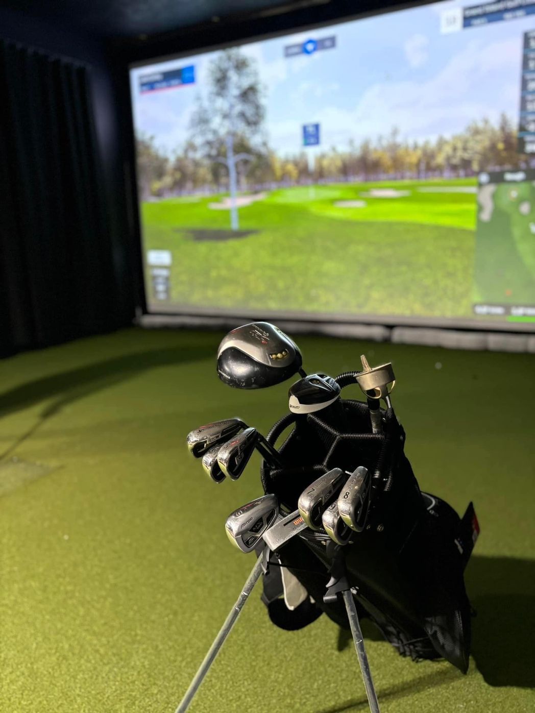Golf bag in front of a simulator screen